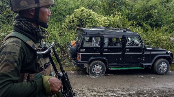 Indian army soldier stands guard neat to a damaged vehicle at the site of an attack at Churachandpur on November 14, 2021, a day after seven soldiers including an Assam Rifles officer, his wife and son were killed in the attack. - Sputnik International