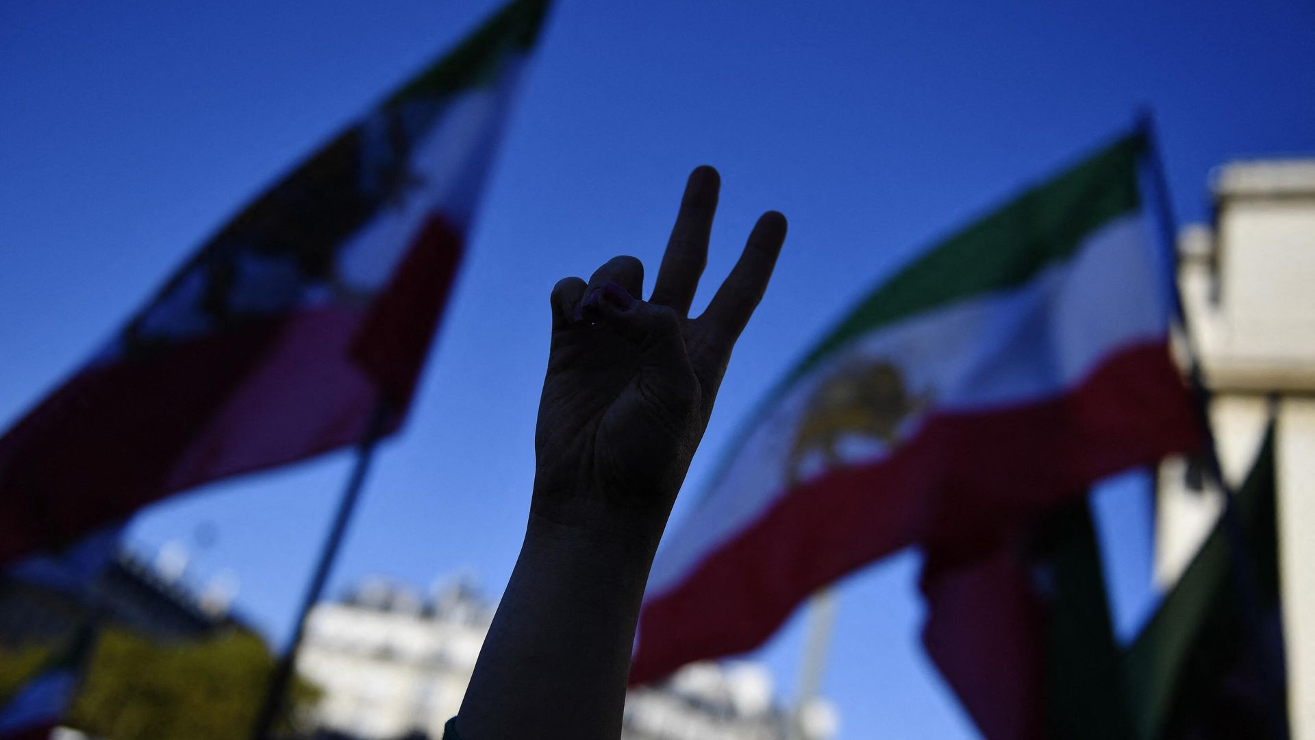 A demonstrator gestures a peace sign during a rally in support of Iranian protests, in Paris,on October 9, 2022, following the death of Iranian woman Mahsa Amini in Iran A demonstrator gestures a peace sign during a rally in support of Iranian protests, in Paris,on October 9, 2022, following the death of Iranian woman Mahsa Amini in Iran - Sputnik International, 1920, 23.11.2022