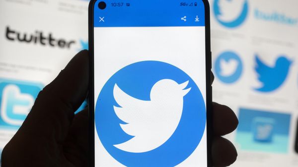The Twitter logo is seen on a cell phone, Friday, Oct. 14, 2022, in Boston.  The “official” designation for major corporate accounts on Twitter appeared, vanished, and depending on the account, appeared or vanished again and some companies took to the social media platform to warn of imposters. - Sputnik International