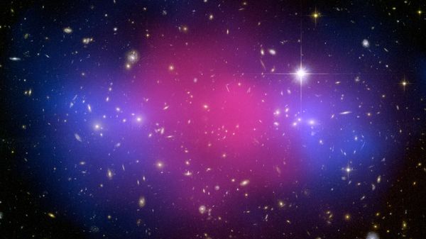 August 27, 2008 image taken by the Hubble Space Telescope and Chandra X-ray Observatory show a clear separation between dark and ordinary matter during the clash 5.7 billion light years from Earth. - Sputnik International