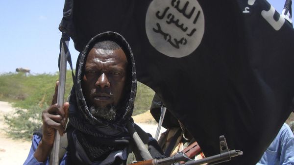 An elderly man from a Somali tribal clan carries an AK-47 and the Islamist black flag with the words There is no God but Allah and Mohamed Is the Prophet of Allah as he vows to fight the Somali government forces and African Union peacekeeping troops in Mogadishu's Maslah Square neighborhood Saturday March 5, 2011. - Sputnik International