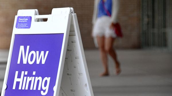 Pedestrians walk by a Now Hiring sign outside a store on August 16, 2021 in Arlington, Virginia - Sputnik International