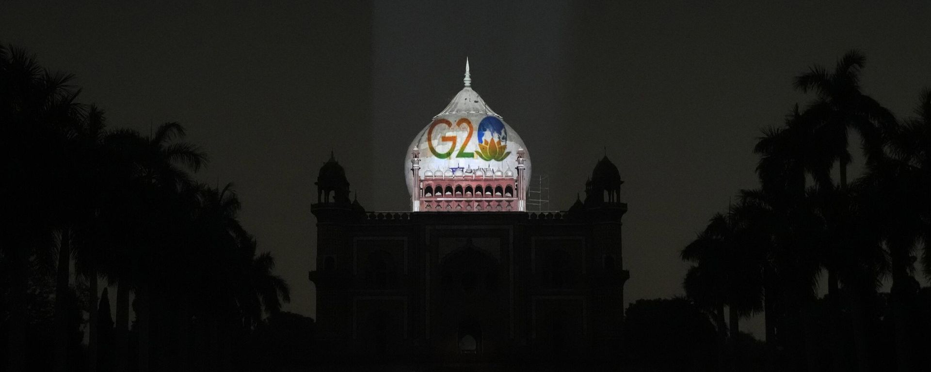 A television correspondent reports standing in front of Safdarjung's tomb lit up with the G20 logo, in New Delhi, Thursday, Dec. 1, 2022. A television correspondent reports standing in front of Safdarjung's tomb lit up with the G20 logo, in New Delhi, Thursday, Dec. 1, 2022. - Sputnik International, 1920, 02.12.2022