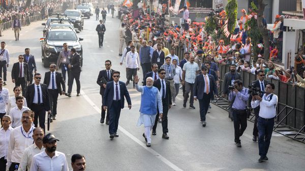 Indian Prime Minister Narendra Modi waves to people as he arrives to cast his vote during the second phase of Gujarat state legislature elections in Ahmedabad, India, Monday, Dec. 5, 2022. - Sputnik International