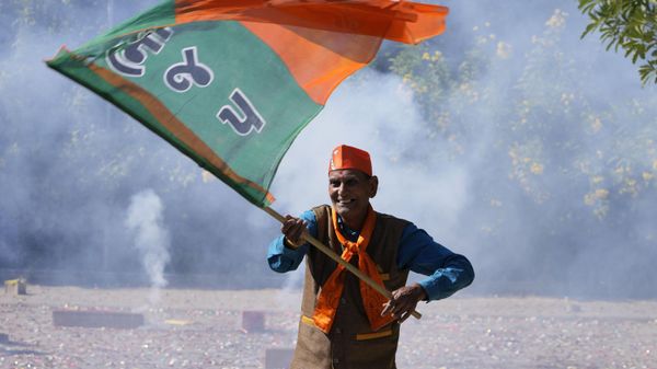 A Bharatiya Janata party (BJP) supporter celebrates lead for the party in Gujarat state elections in Gandhinagar, India, Thursday, Dec. 8, 2022. - Sputnik International
