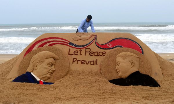 Indian artist Sudarshan Pattnaik, 65, finishes a sand sculpture depicting US President Donald Trump and North Korea's leader Kim Jong-un at Puri beach, some 65 km away from Bhubaneswar on June 11, 2018, ahead of the US-North Korea summit. Kim Jong Un and Donald Trump met on June 12 for an unprecedented summit in an attempt to address the last festering legacy of the Cold War, with the US president calling it a "one time shot" at peace. - Sputnik International