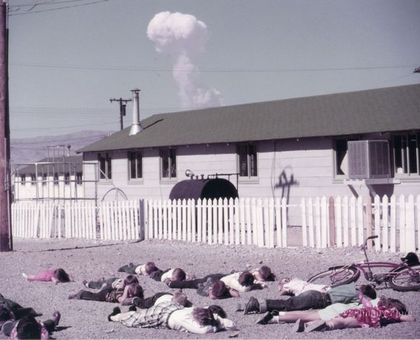 Students practice "duck and cover" personal protection measures against the backdrop of a real atomic bomb explosion. The photo was taken in Indian Springs, Nevada, 40 kilometers from the epicenter of a 31-kiloton aerial atomic bomb explosion. Date and time: April 22, 1952, 09:30. - Sputnik International