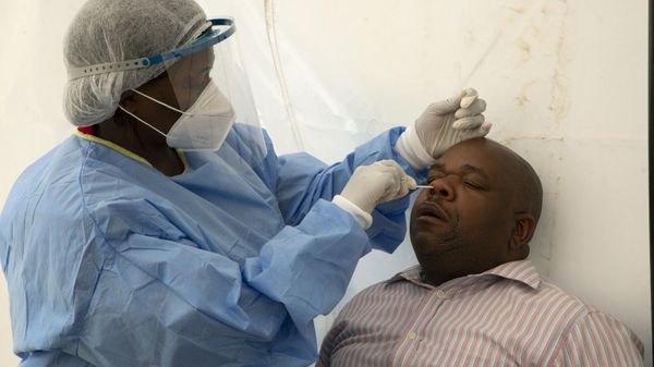 A patient undergoes a nasal swab to check for COVID-19 at a testing center in Soweto, South Africa, on May 11, 2022. - Sputnik International