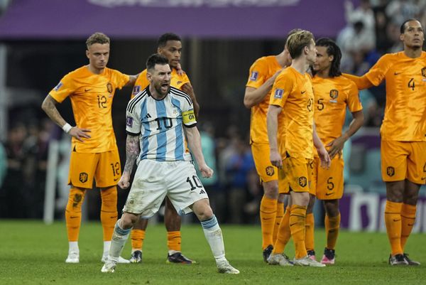 Argentina's Lionel Messi celebrates in front of players from the Netherlands at the end of the World Cup quarterfinal soccer match between the Netherlands and Argentina, at the Lusail Stadium in Lusail, Qatar, Saturday, December 10, 2022. Argentina defeated the Netherlands 4-3 in a penalty shootout after the match ended tied 2-2.(AP Photo/Jorge Saenz) - Sputnik International