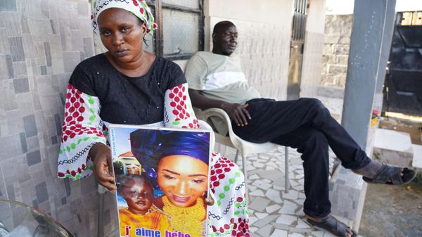 Mariama Kuyateh, 30, holds up a picture of her late son Musawho died from acute kidney failure, in Banjul on October 10, 2022 - Sputnik International