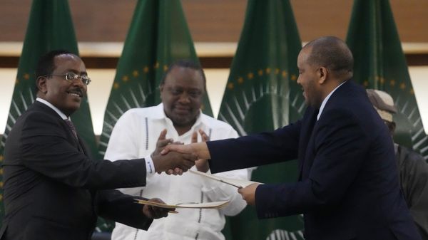 Lead negotiator for Ethiopia’s government, Redwan Hussein, left, shakes hands with lead Tigray negotiator Getachew Reda, as Kenya's former president, Uhuru Kenyatta, looks on, after the peace talks in Pretoria, South Africa, Wednesday, Nov. 2, 2022. Ethiopia’s warring sides have formally agreed to a permanent cessation of hostilities, an African Union special envoy said Wednesday, after a two-year conflict whose victims could be counted in the hundreds of thousands. - Sputnik International
