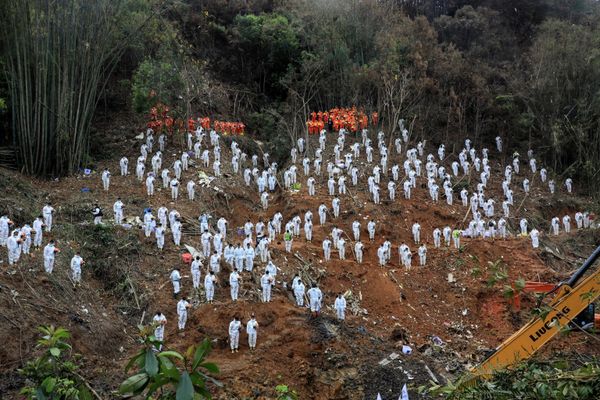This photo taken on March 27, 2022, shows rescuers standing in a silent tribute for victims at the site of the China Eastern Airlines plane crash in Tengxian county, Wuzhou city, in China's southern Guangxi region. The Boeing 737-800 was flying between the cities of Kunming and Guangzhou on March 21 when it nosedived into a mountainside, disintegrating on impact and killing all 132 people on board. - Sputnik International
