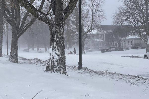 A person clears snow from the sidewalk during a snowstorm on Saturday, Dec. 24, 2022 in Buffalo, N.Y. Gov. Kathy Hochul said Saturday that the the Buffalo Niagara International Airport will be closed through Monday morning, some roads would be closed through Christmas day and almost every fire truck in Buffalo was stranded in the snow. - Sputnik International