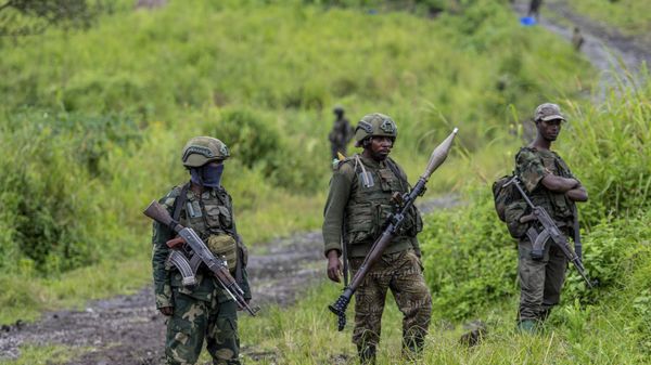 A M23 rebels stand with theirs weapons during a ceremony to mark the withdrawal from their positions in the town of Kibumba, in the eastern of Democratic Republic of Congo, on Dec. 23, 2022. The accounts are haunting. Abductions, torture, rapes. Scores of civilians including women and children have been killed by the M23 rebels in eastern Congo, according to a U.N. report expected to be published this week. A M23 rebels stand with theirs weapons during a ceremony to mark the withdrawal from their positions in the town of Kibumba, in the eastern of Democratic Republic of Congo, on Dec. 23, 2022. The accounts are haunting. Abductions, torture, rapes. Scores of civilians including women and children have been killed by the M23 rebels in eastern Congo, according to a U.N. report expected to be published this week. - Sputnik International