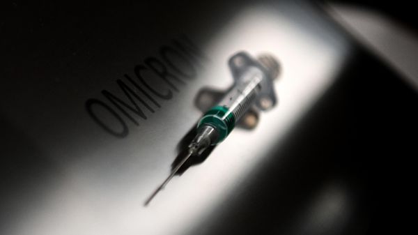 An illustration picture taken on January 19, 2022, shows a syringe next to the word Omicron.  - Sputnik International