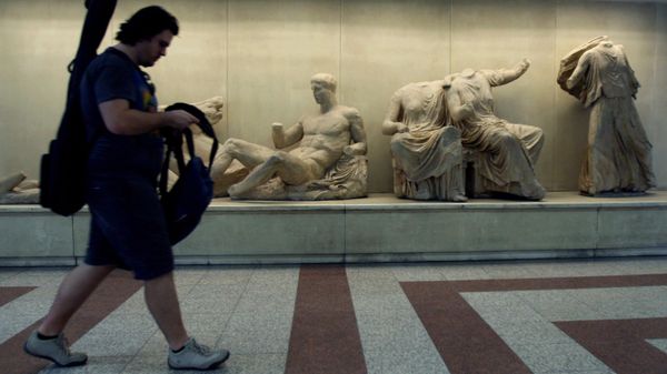 A passenger walks past copies of some of the Parthenon Sculptures displayed in the British Museum, at the Acropolis Metro station in Athens, on Thursday, June 11, 2009.  - Sputnik International
