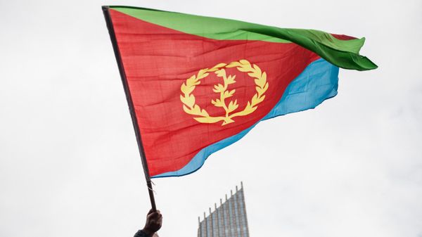 A man waves an Eritrean national flag as hundreds of Eritreans demonstrate in front of the African Union headquarters in support of the UN Inquiry report and asking for measures to be taken against Eritrea on June 26, 2015 in Addis Ababa. A man waves an Eritrean national flag as hundreds of Eritreans demonstrate in front of the African Union headquarters in support of the UN Inquiry report and asking for measures to be taken against Eritrea on June 26, 2015 in Addis Ababa. - Sputnik International