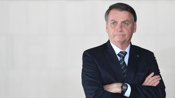 Brazil's then-President Jair Bolsonaro waits before a family photo at the 11th BRICS leaders summit, in Brazilia, Brazil. - Sputnik International