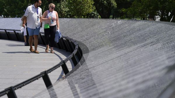 Visitors walk past the Korean War Veterans Memorial's newly unveiled Wall of Remembrance after a dedication ceremony, Wednesday, July 27, 2022, in Washington. - Sputnik International