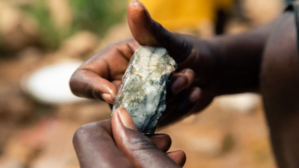 A young miner looks at an ore sample searching for gold during a mine search and rescue operation at Cricket Mine in Kadoma, Mashonaland West Province where more than 23 artisinal miners are trapped underground and feared dead on February 15, 2019.  - Sputnik International