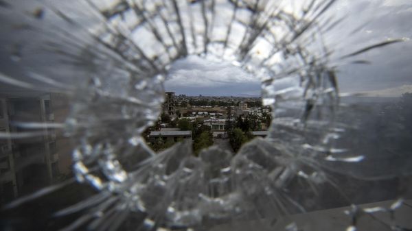 The city of Mekele is seen through a bullet hole in a stairway window of the Ayder Referral Hospital in the Tigray region of northern Ethiopia on May 6, 2021 - Sputnik International