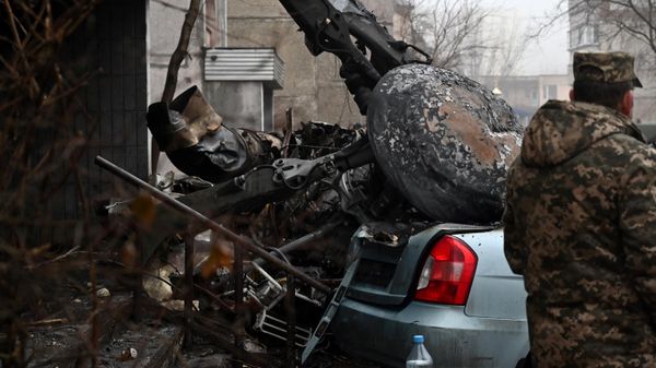 A military stands at the site where a helicopter crashed near a kindergarten in Brovary, outside the capital Kiev, on January 18, 2023 - Sputnik International