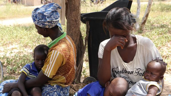 Two women sit outside a small clinic in Gampela village on the outskirts of Burkina Faso's capital, Ouagadougou, Saturday Oct. 10, 2020, waiting to take their children to the doctor. - Sputnik International