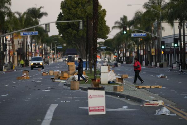 Residents walk across a Lunar New Year festival site after it was canceled because of a mass shooting nearby in Monterey Park, California, on Sunday, 22 January 2023. - Sputnik International