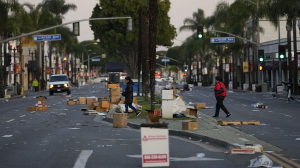 Residents walk across a Lunar New Year festival site after it was canceled due to a mass shooting nearby in Monterey Park, California, Sunday, January 22, 2023. - Sputnik International