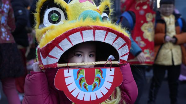 A young performer looks out of a dragon mask ahead of the Lunar New Year parade in London, Sunday, Jan. 22, 2023. The parade is to mark the arrival of the Year of the Rabbit, with thousands of visitors expected to watch the spectacular show and Lion Dances in the capital.  - Sputnik International