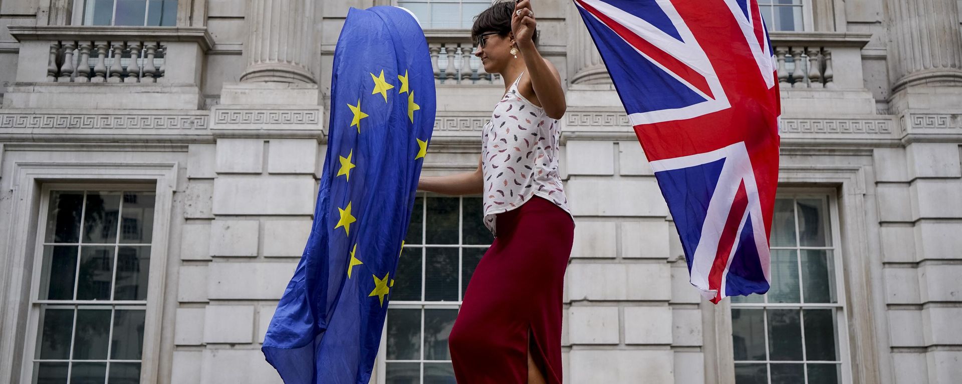 An anti-Brexit demonstrator whirls an EU and Union Flag during a demonstration against the British government's move to suspend parliament in the final weeks before Brexit outside Downing Street in London on August 31, 2019 An anti-Brexit demonstrator whirls an EU and Union Flag during a demonstration against the British government's move to suspend parliament in the final weeks before Brexit outside Downing Street in London on August 31, 2019 - Sputnik International, 1920, 24.01.2023