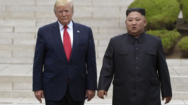 Then US President Donald Trump, left, meets with North Korean leader Kim Jong-Un at the North Korean side of the border at the village of Panmunjom in Demilitarized Zone, on June 30, 2019. - Sputnik International