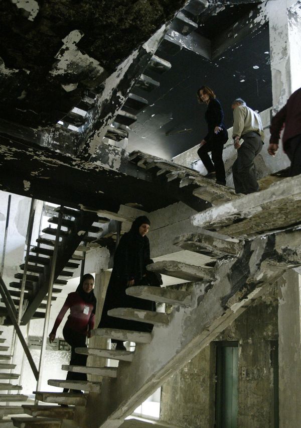 Employees of Baghdad's al-Muthanna Library climb the stairs inside a burnt out section of the building on March 13, 2004, nearly one year after it was ransacked by looters. The library was looted and set on fire on April 13, 2003, four days after the fall of Baghdad to US-led coalition forces. Known as the National Library, it was built in 1961 and was home to Iraq's national archives.  AFP PHOTO/Joseph BARRAK (Photo by JOSEPH BARRAK / AFP) - Sputnik International