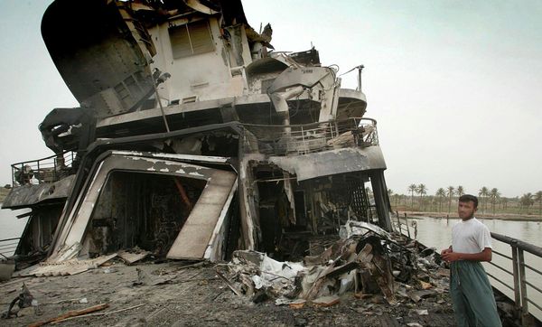 Damage to the stern of the 'Al Mansur', Saddam Hussein's private yacht, is seen on April 10, 2003, as the yacht drifts near Basra. The vessel, which was nearly 400 feet long and was reputed to be able to accommodate some 200 guests, was heavily bombed by British forces. (AP Photo/Simon Walker, Pool) - Sputnik International