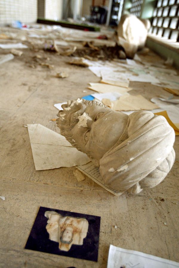 Parts of a beheaded sculpture lie among rubble after a mob of looters ransacked and looted Iraq's largest archeological museum in Baghdad, April 13, 2003. The pillaging of the Iraqi National Museum in the immediate aftermath of Baghdad's fall in April 2003 shocked the world, but while many of those antiquities have since been recovered, the looting has taken off in the archaeological sites scattered around the perilous countryside. AFP PHOTO PATRICK BAZ (Photo by PATRICK BAZ / AFP) - Sputnik International