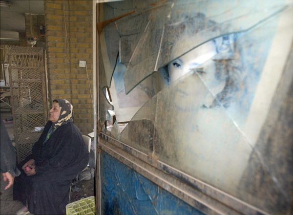 The owner of a flower shop outside a Baghdad maternity clinic sits in front of her damaged shop after a US-British air raid on April 2, 2003. The Red Crescent clinic was hit in air strikes over Baghdad.   AFP PHOTO/Karim SAHIB (Photo by KARIM SAHIB / AFP) - Sputnik International