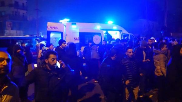 In this video grab from AFP TV taken on February 6, 2023, people stand next to an ambulance as rescuers search for victims of a 7.8-magnitude earthquake that hit Diyarbakir, in southeastern Turkey, levelling buildings across several cities and causing damages in neighbouring Syria. - Sputnik International