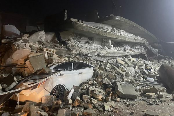 A car is seen under the wreckage of a collapsed building, in Azmarin town, in Idlib province, northern Syria, Monday, Feb. 6, 2023. (AP Photo/Ghaith Alsayed) - Sputnik International