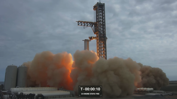 Screenshot captures moment in which SpaceX carried out a static fire of its Super Heavy Booster at the Starbase Boca Chica facility in Texas. - Sputnik International