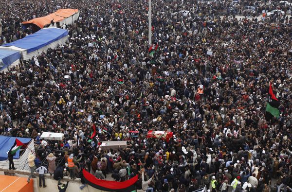 Libyan mourners carry the coffins of three protesters who were killed during the demonstrations against Libyan leader Muammar Gaddafi, in Benghazi, Libya, on Friday 25 February 2011. - Sputnik International