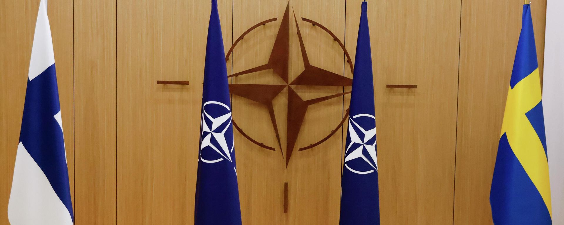 Flags of Finland, left, NATO and Sweden, right, are displayed during a ceremony to mark Sweden's and Finland's application for membership in Brussels, Belgium, Wednesday May 18, 2022. - Sputnik International, 1920, 03.07.2023