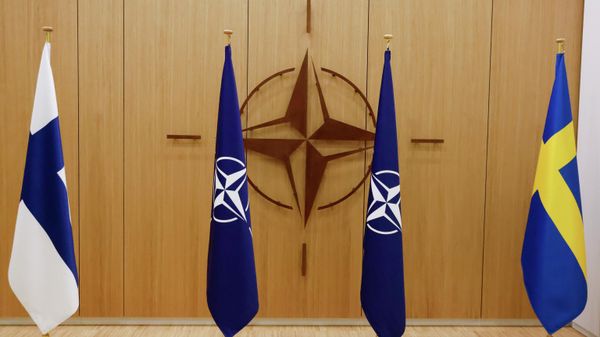 Flags of Finland, left, NATO and Sweden, right, are displayed during a ceremony to mark Sweden's and Finland's application for membership in Brussels, Belgium, Wednesday May 18, 2022. - Sputnik International