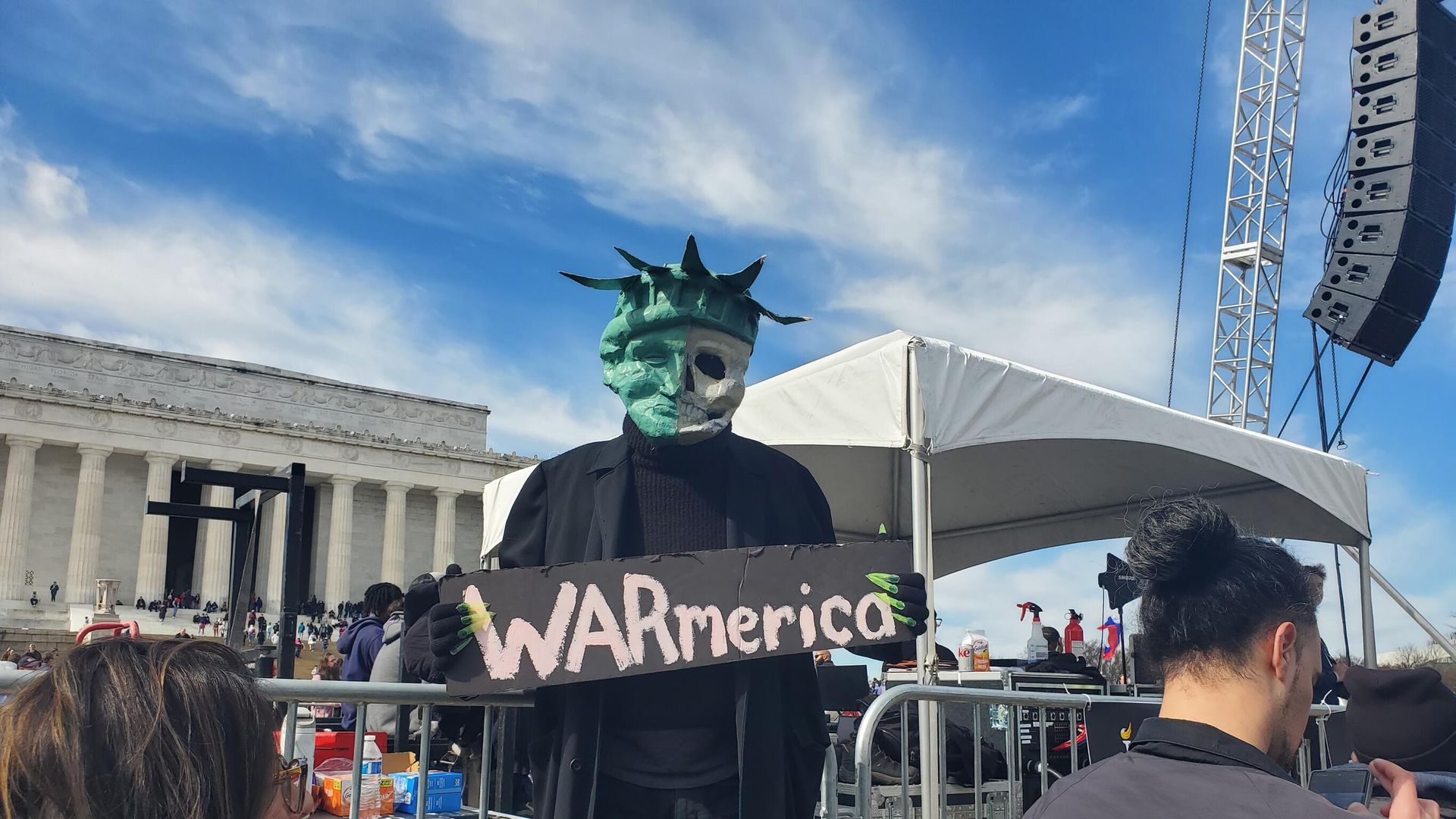 A protester holds a sign saying WARmerica at the Rage Against the War Machine Rally in Washington DC on February 19, 2023 A protester holds a sign saying WARmerica at the Rage Against the War Machine Rally in Washington DC on February 19, 2023 - Sputnik International, 1920, 20.02.2023