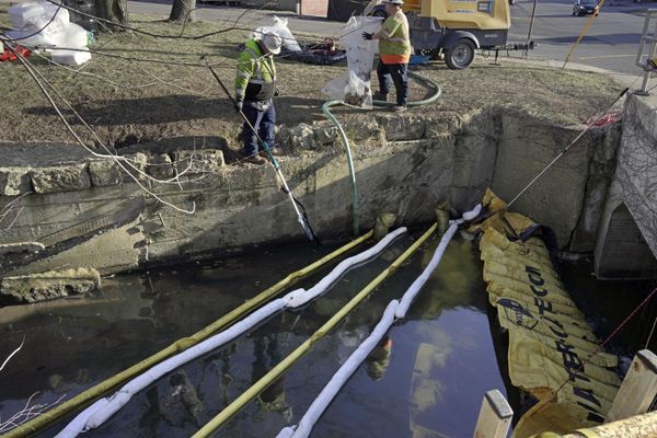 Booms are placed in a stream that flows through the center of East Palestine, Ohio, as cleanup continues following the derailment of a Norfolk Southern freight train. (AP Photo/Gene J. Puskar) - Sputnik International