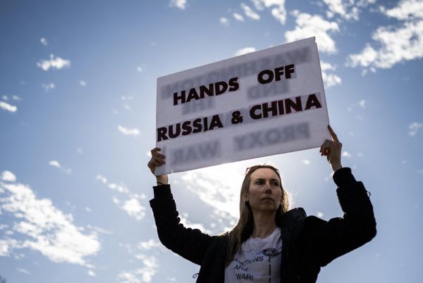 A protestor holds a sign during an antiwar rally at the Lincoln Memorial in Washington, DC, on February 19, 2023. - Sputnik International