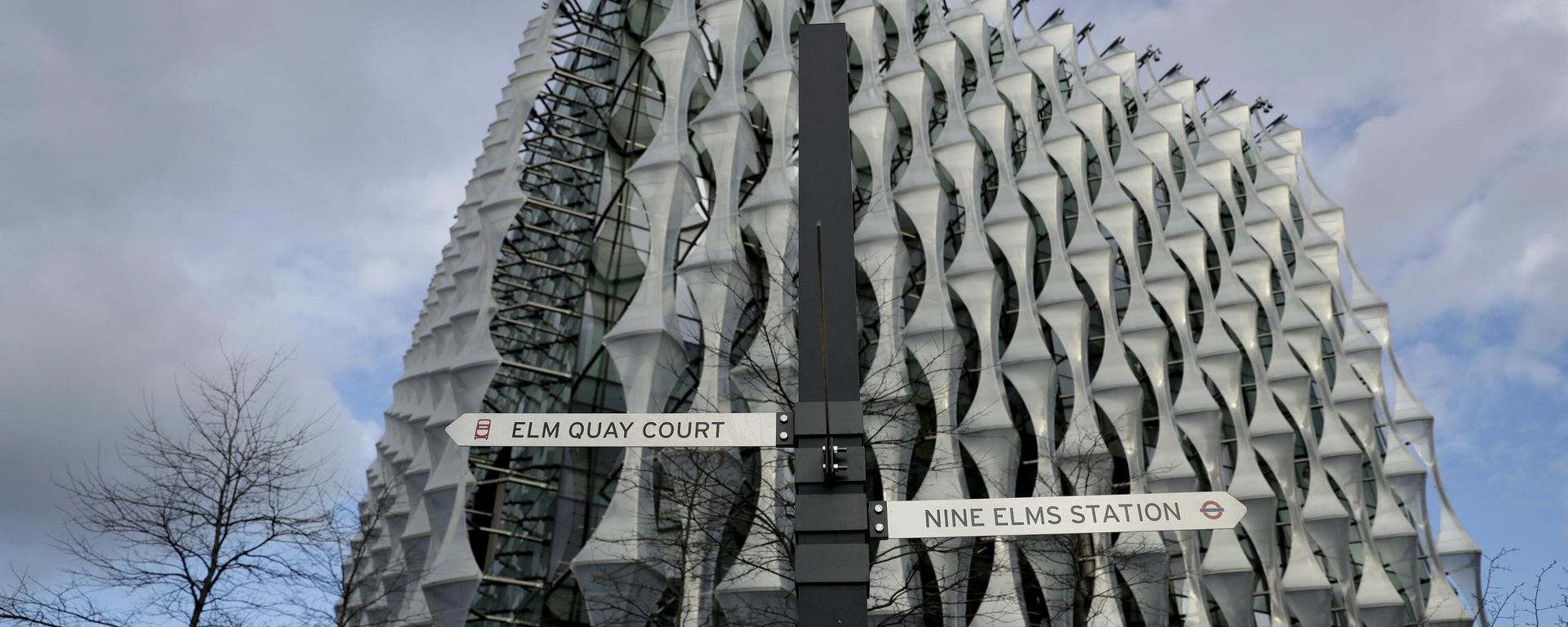 A sign for Nine Elms underground train station stands outside the new United States Embassy building in London. - Sputnik International, 1920, 22.02.2023
