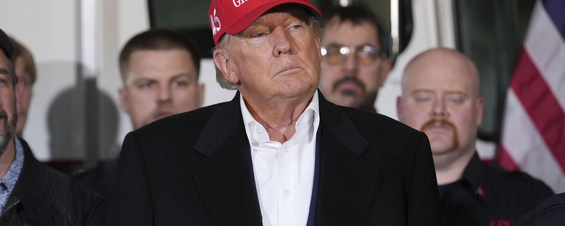 Former President Donald Trump listens to speakers at the East Palestine Fire Department as he visits the area in the aftermath of the Norfolk Southern train derailment Feb. 3 in East Palestine, Ohio, Wednesday, Feb. 22, 2023. - Sputnik International, 1920, 20.12.2023