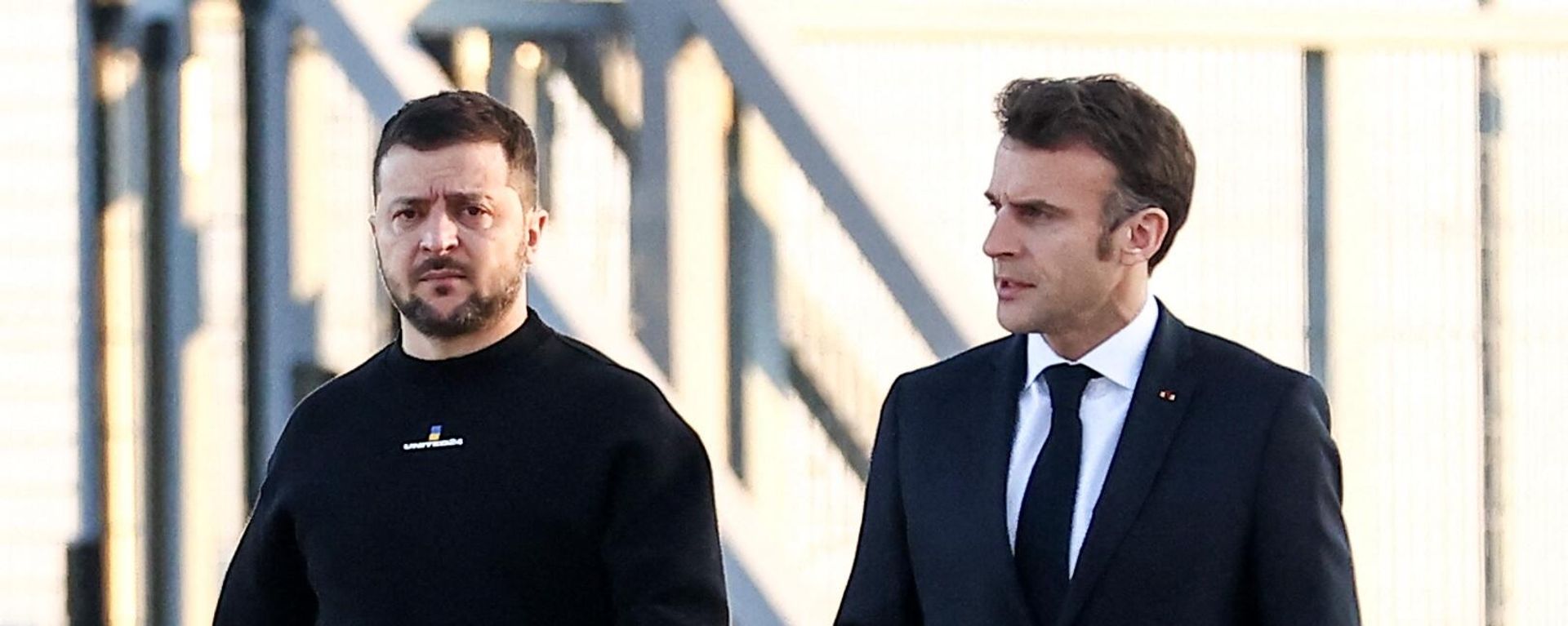 France's President Emmanuel Macron (R) and Ukrainian President Volodymyr Zelensky walk on the tarmac of Velizy-Villacoublay airbase as they prepare to board a flight together, en route to Brussels for a summit at EU parliament, on February 9, 2023 France's President Emmanuel Macron (R) and Ukrainian President Volodymyr Zelensky walk on the tarmac of Velizy-Villacoublay airbase as they prepare to board a flight together, en route to Brussels for a summit at EU parliament, on February 9, 2023 - Sputnik International, 1920, 25.02.2023