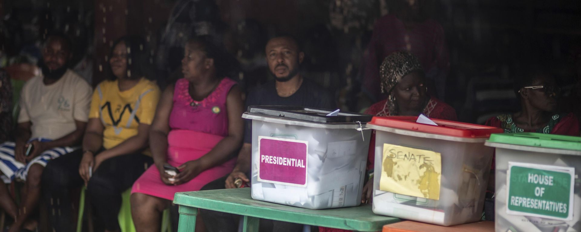 People sit in line next to the ballot boxes displayed on the tables, as they wait to cast their votes at a polling station during the presidential elections in Agulu, Nigeria, Saturday, Feb. 25, 2023. People sit in line next to the ballot boxes displayed on the tables, as they wait to cast their votes at a polling station during the presidential elections in Agulu, Nigeria, Saturday, Feb. 25, 2023. - Sputnik International, 1920, 26.02.2023
