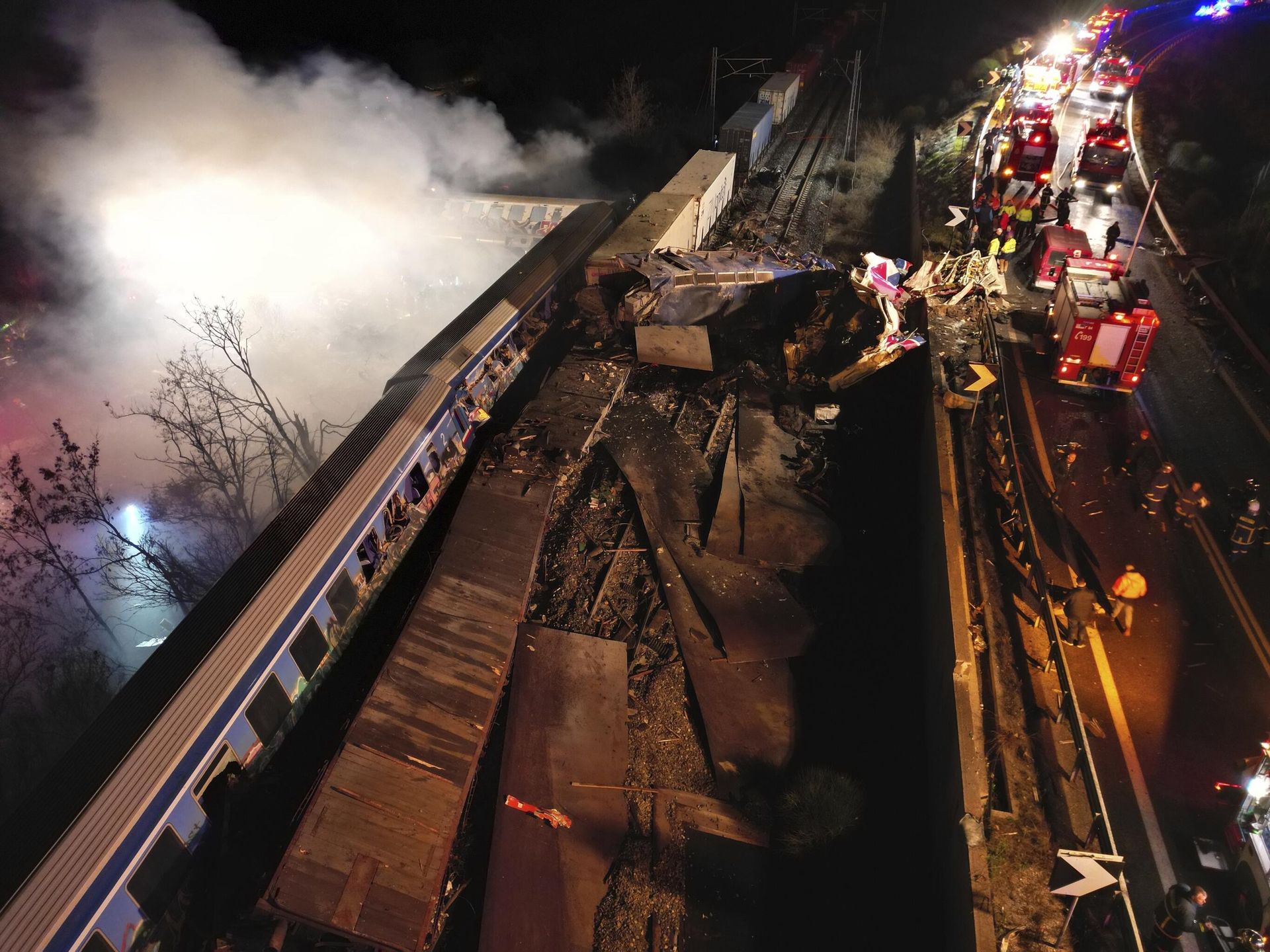 Smoke rises from trains as firefighters and rescuers operate after a collision near Larissa city, Greece, early Wednesday, March 1, 2023. The collision between a freight and passenger train occurred near Tempe, some 380 kilometers (235 miles) north of Athens, and resulted in the derailment of several train cars. Smoke rises from trains as firefighters and rescuers operate after a collision near Larissa city, Greece, early Wednesday, March 1, 2023. The collision between a freight and passenger train occurred near Tempe, some 380 kilometers (235 miles) north of Athens, and resulted in the derailment of several train cars. - Sputnik International, 1920, 01.03.2023